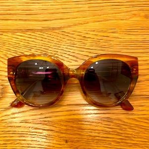 Tom’s oversized sunglasses